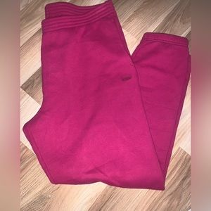 TNA sweatfleece/cozy fleece sweatpants. they are in the colour “bold fuchsia”.